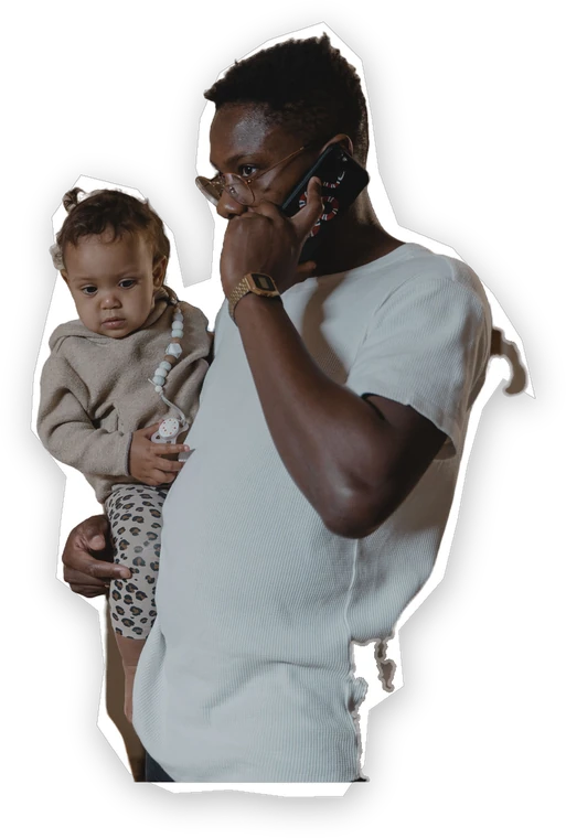 A father holding his baby, taking a call