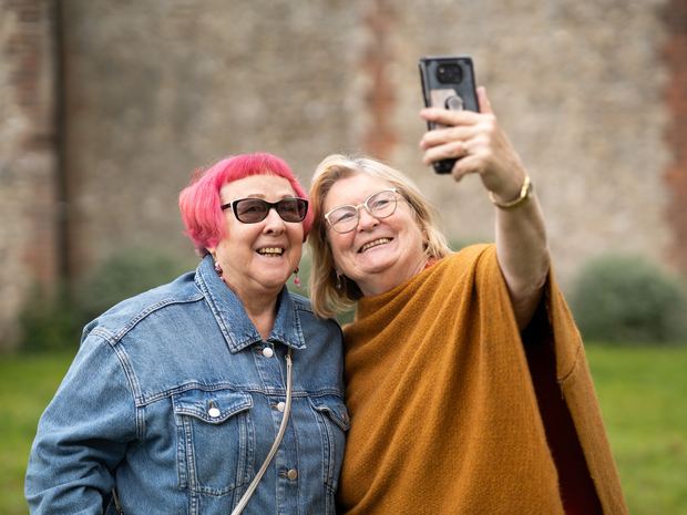 Two older women taking a selfie together.